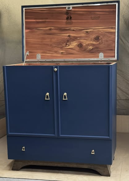 Blue painted cabinet styled with vintage wall art