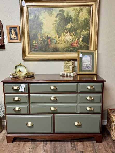 Green dresser vignette with vintage art and collected small decor