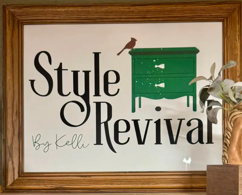The Style Revival by Kelli sign hanging in her booth: a green dresser with a red cardinal